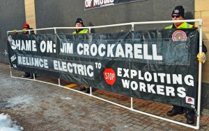 Members of the International Brotherhood of Electrical Workers man a banner outside the Lowry Building in St. Paul.