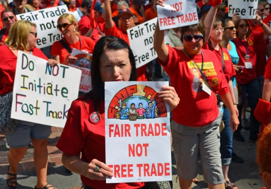 More than 200 people, many delegates to the CWA District 7 Convention, march along Nicollet Mall to a rally against fast-track approval of the Trans-Pacific Partnership trade agreement.
