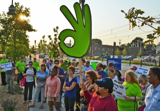 Members of OUR Walmart Minnesota and their supporters demonstrate outside the retailer's Midway location.