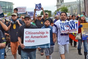 Members of District Council 82 of the Painters and Allied Trades and their families march together, wearing black union T-shirts.