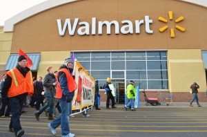 Carrying a banner that read "End Poverty Wages in Minnesota," demonstrators march past the Midway Walmart's entrance in St. Paul on Black Friday.