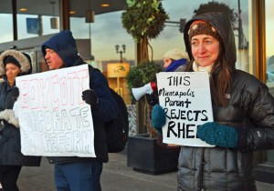 Jenny Warner, a parent of two students in the Minneapolis Public Schools, joins the demonstration outside the Education Summit.