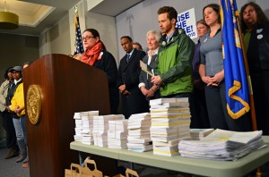 Organizers of the Raise the Wage Coalition held a press conference before delivering thousands of postcards to state senators from supporters of a $9.50 minimum wage.