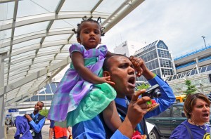 Airserv worker Abera Siyoum marches with his daughter Coket.