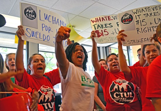 Striking workers rally inside a McDonald's in Uptown Minneapolis.
