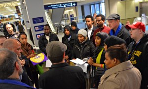 Airserv workers deliver a petition to a representative of the Metropolitan Airports Commission.