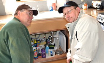 Local 34 members Gerald Keating (L) and Brett Sergot volunteered together during the Water's Off day of service March 21.