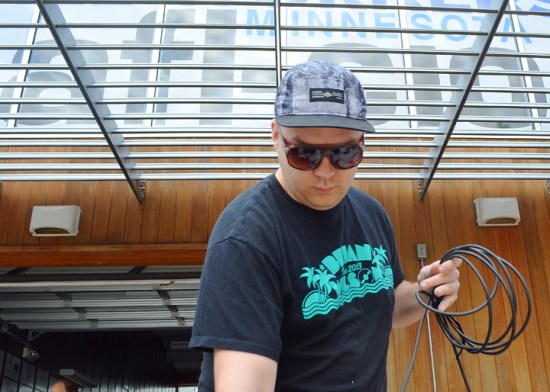 Merritt Benton, a member of IATSE Local 13, runs cords along the Labor Pavilion’s stage. Local 13 donated, installed and will run the pavilion's sound and stage.