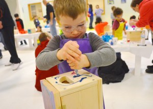 Luca LaFerla puts the finishing touches on his treasure box during a Kids Build workshop at the Carpenters training center in St. Paul.