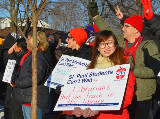 Members of the St. Paul Federation of Teachers rally with supporters before walking into the Teachers at American Indian Magnet School in St. Paul.