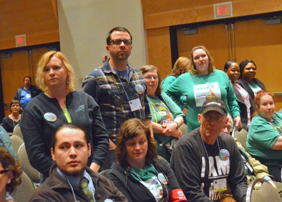 Workers who have been injured or assaulted on the job at a state mental health facility stand up during AFSCME Council 5's Day on the Hill rally.