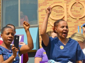 Golden Living Center workers Rhoda Brown (L) and Tsge Abraham rally for a fair contract outside the company's Lakeridge site in Roseville.