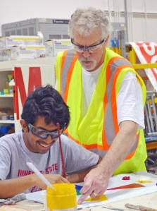 At the IUPAT District Council 82 training center in Little Canada, apprenticeship instructor Kerry Gallagher offers tips on filling in the color wheel to Randy Cuate of Minneapolis Roosevelt.