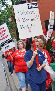 Picketers walk the sidewalk outside United Hospital in St. Paul shortly after MNA's strike began on Labor Day.