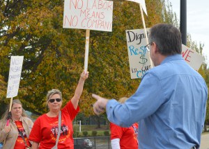Union member lifting picket sign during rally.